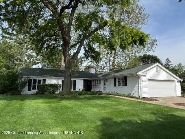 1654 Nottingham Rd, Lansing, MI 48911 - single story home featuring a garage, a front lawn, driveway, and a chimney