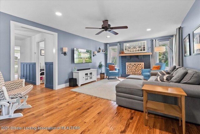 520 Wood St, Eaton Rapids, MI 48827 - living room with a ceiling fan, plenty of natural light, light wood-style flooring, a brick fireplace, and recessed lighting