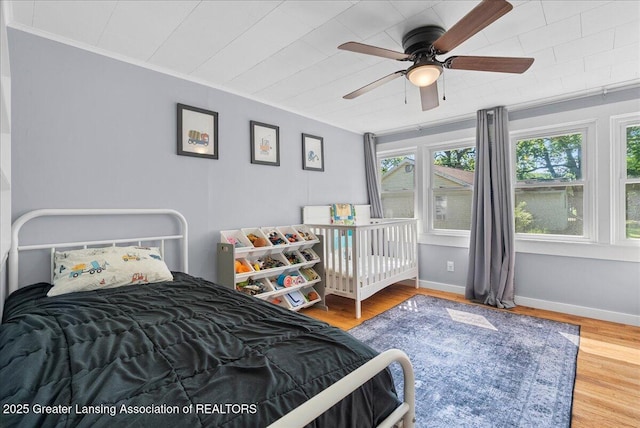 520 Wood St, Eaton Rapids, MI 48827 - bedroom with ornamental molding, wood finished floors, and a ceiling fan