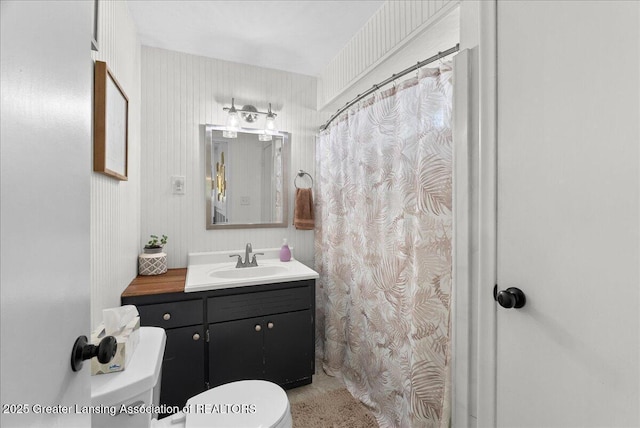 520 Wood St, Eaton Rapids, MI 48827 - bathroom with vanity, a shower with shower curtain, and wallpapered walls