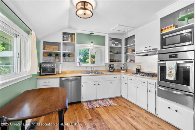 520 Wood St, Eaton Rapids, MI 48827 - kitchen with open shelves, stainless steel appliances, a warming drawer, under cabinet range hood, and lofted ceiling