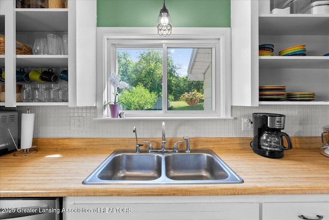 520 Wood St, Eaton Rapids, MI 48827 - kitchen with white cabinets, backsplash, light countertops, and dishwasher