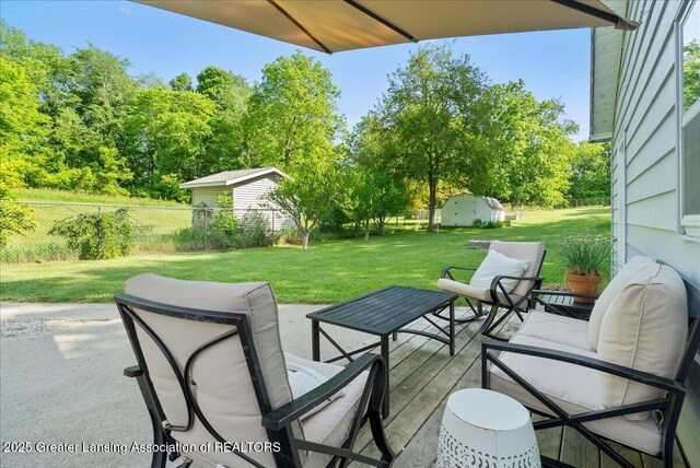 520 Wood St, Eaton Rapids, MI 48827 - view of patio featuring view of wooded area and a storage shed