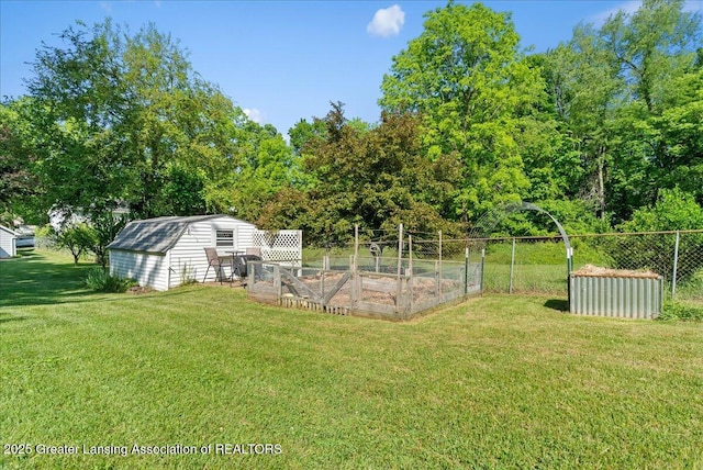 520 Wood St, Eaton Rapids, MI 48827 - view of yard featuring a vegetable garden and an outbuilding
