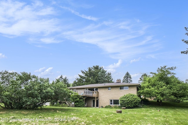 13433 S Grange Rd, Eagle, MI 48822 - back of property with a yard, a chimney, and a deck