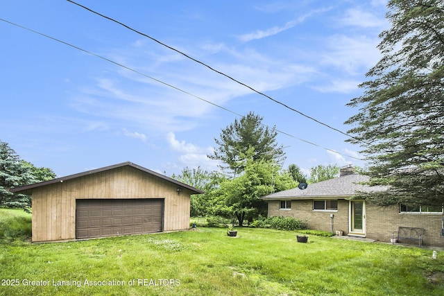 13433 S Grange Rd, Eagle, MI 48822 - view of grassy yard with a garage and an outdoor structure