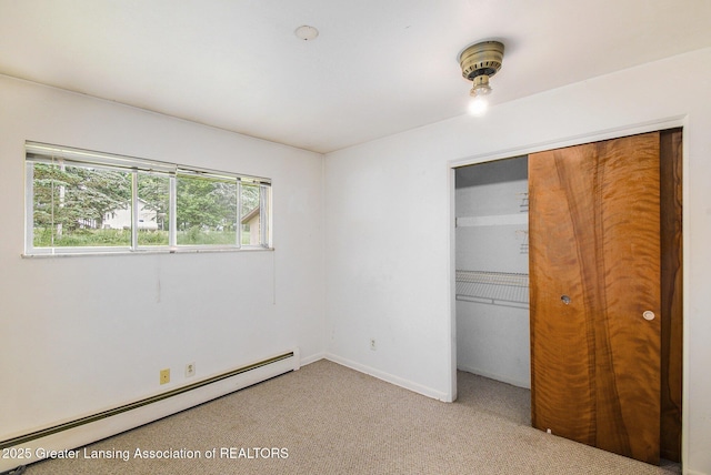 13433 S Grange Rd, Eagle, MI 48822 - unfurnished bedroom with a baseboard radiator, a closet, and light colored carpet