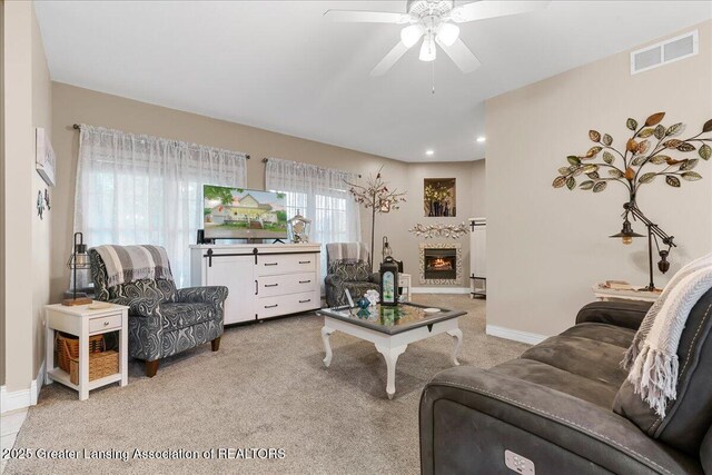 8805 E Cole Rd, Durand, MI 48429 - carpeted living room featuring a ceiling fan, recessed lighting, and a lit fireplace