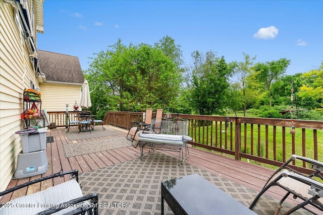 8805 E Cole Rd, Durand, MI 48429 - deck featuring outdoor dining space, a lawn, and view of scattered trees