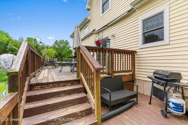 8805 E Cole Rd, Durand, MI 48429 - deck featuring outdoor dining space, stairway, and a grill