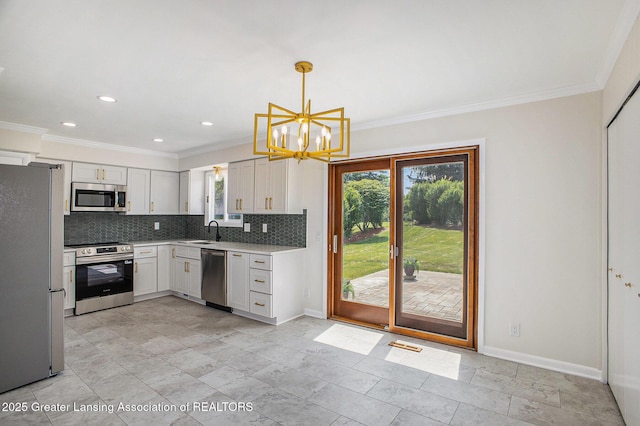 3861 New Salem Ave, Okemos, MI 48864 - kitchen with stainless steel appliances, crown molding, light countertops, tasteful backsplash, and a chandelier