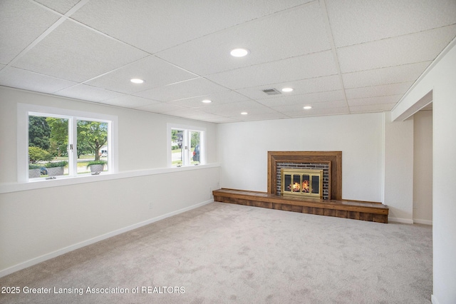 3861 New Salem Ave, Okemos, MI 48864 - unfurnished living room featuring carpet flooring, a glass covered fireplace, recessed lighting, and a drop ceiling