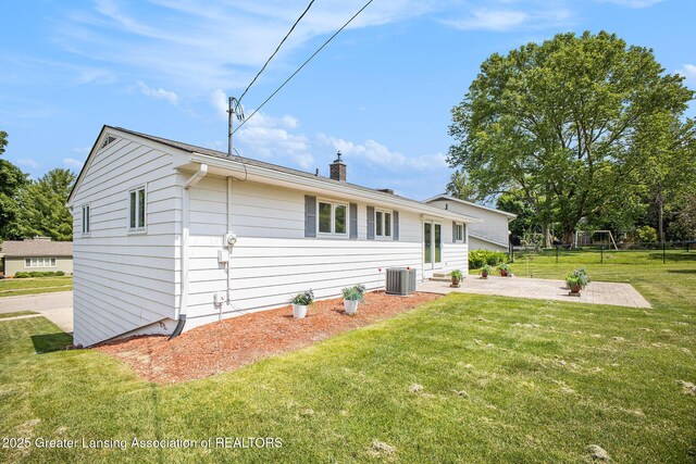 3861 New Salem Ave, Okemos, MI 48864 - view of side of property with a patio, a chimney, and a lawn