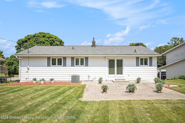 3861 New Salem Ave, Okemos, MI 48864 - back of house with a patio area, a lawn, a chimney, and roof with shingles