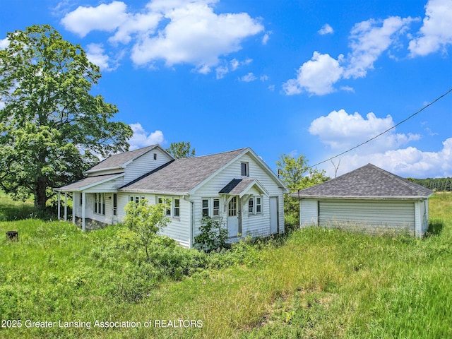 4548 Matthews Rd, Charlotte, MI 48813 - view of front of home with roof with shingles and a detached garage
