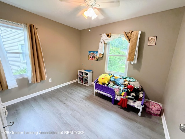 874 Brookdale St, Mason, MI 48854 - playroom featuring ceiling fan and wood finished floors