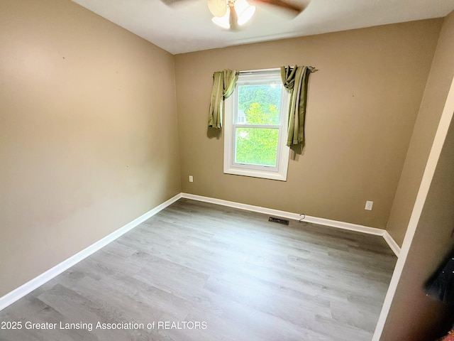 874 Brookdale St, Mason, MI 48854 - empty room with a ceiling fan and wood finished floors