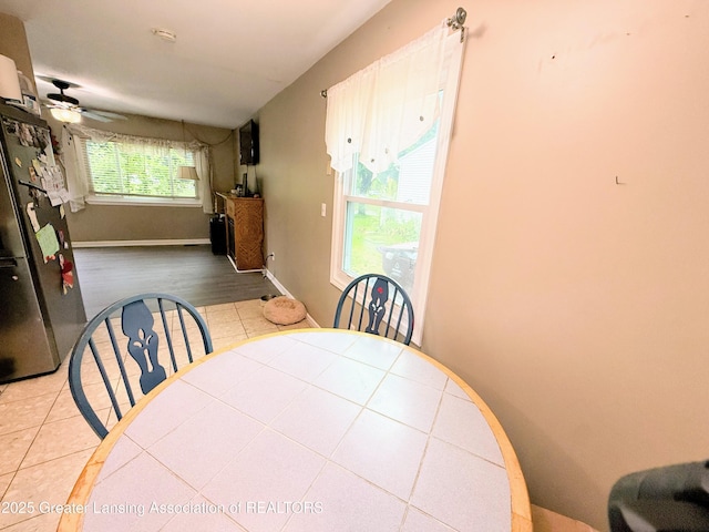 874 Brookdale St, Mason, MI 48854 - tiled dining area with ceiling fan and baseboards