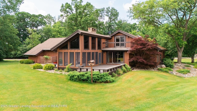280 Winterberry Ln, Okemos, MI 48864 - rear view of house with a chimney, a lawn, a sunroom, a balcony, and a wooden deck