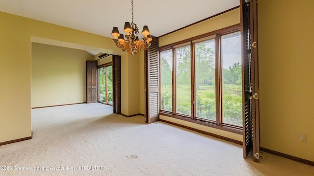 280 Winterberry Ln, Okemos, MI 48864 - carpeted empty room featuring baseboards and a chandelier