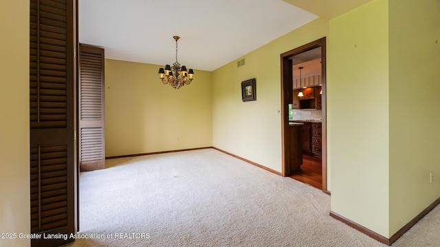 280 Winterberry Ln, Okemos, MI 48864 - unfurnished room featuring light carpet and a chandelier