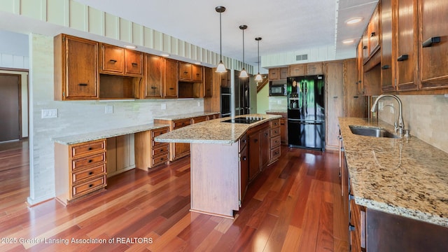 280 Winterberry Ln, Okemos, MI 48864 - kitchen with black appliances, a center island, dark wood-style floors, and backsplash