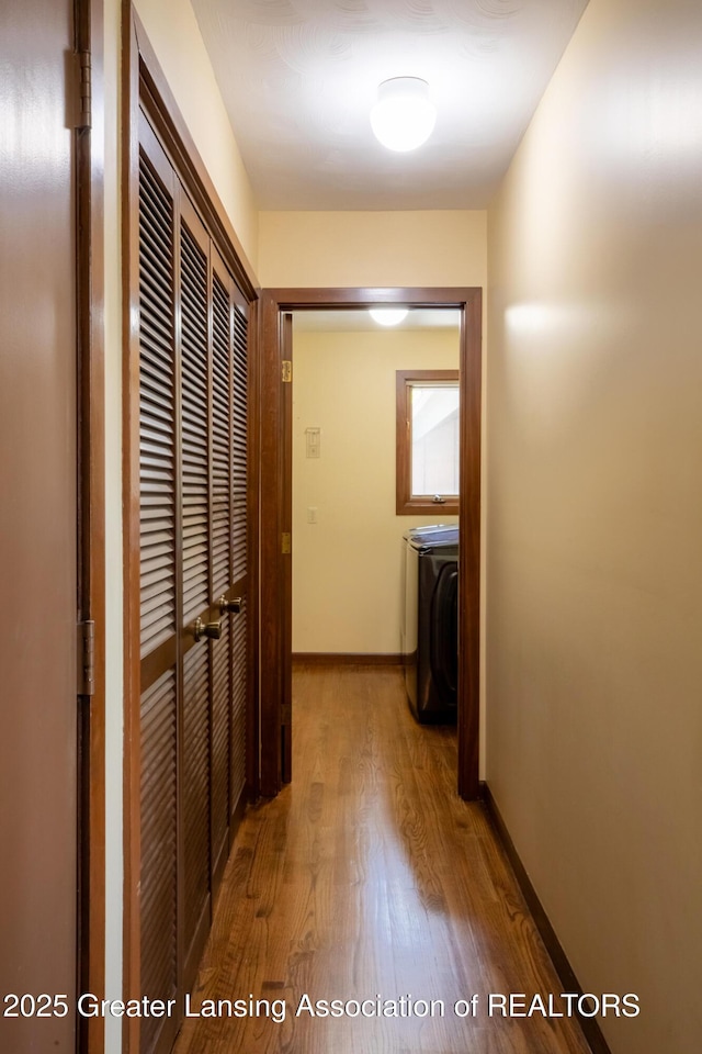 280 Winterberry Ln, Okemos, MI 48864 - hallway with wood finished floors and washer / clothes dryer