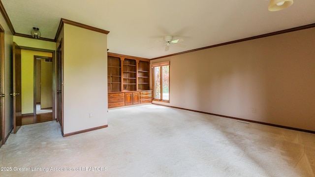 280 Winterberry Ln, Okemos, MI 48864 - empty room with ornamental molding, a ceiling fan, light colored carpet, and built in shelves