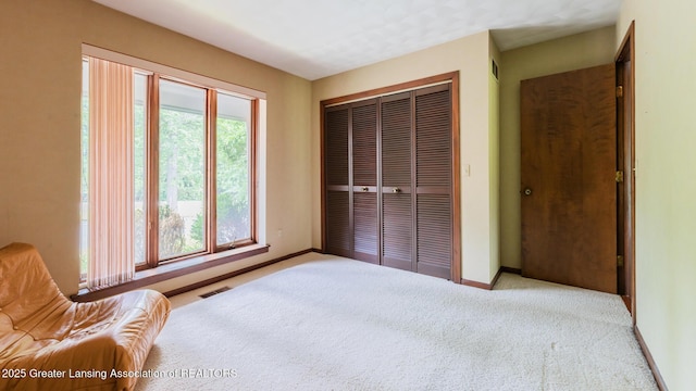 280 Winterberry Ln, Okemos, MI 48864 - carpeted bedroom with a closet and baseboards