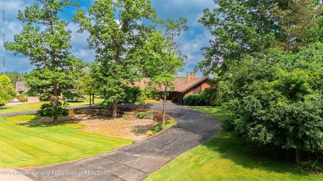 280 Winterberry Ln, Okemos, MI 48864 - obstructed view of property featuring a front lawn and asphalt driveway