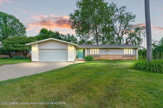 10138 Baron Blvd, Dimondale, MI 48821 - ranch-style home with an attached garage, concrete driveway, a front lawn, a chimney, and brick siding