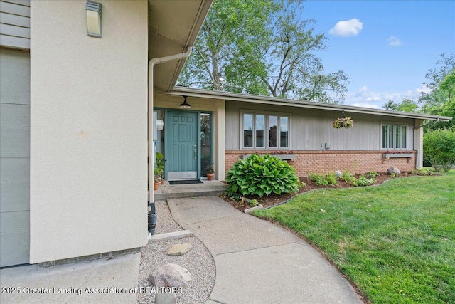 10138 Baron Blvd, Dimondale, MI 48821 - property entrance with brick siding and a yard