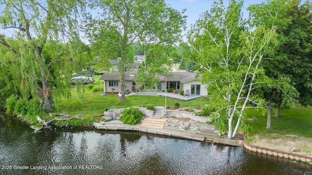 10138 Baron Blvd, Dimondale, MI 48821 - rear view of house with a water view, a yard, and a patio area