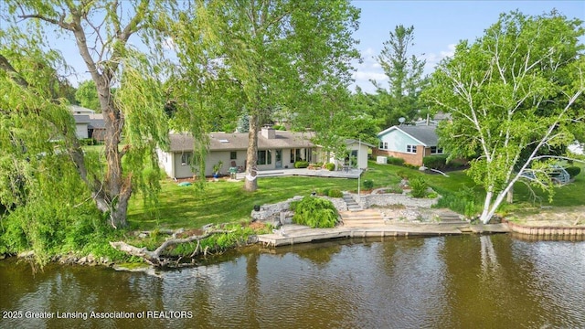 10138 Baron Blvd, Dimondale, MI 48821 - back of house featuring a water view, a patio area, and a lawn