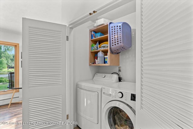 10138 Baron Blvd, Dimondale, MI 48821 - laundry room featuring washer and dryer and wood finished floors