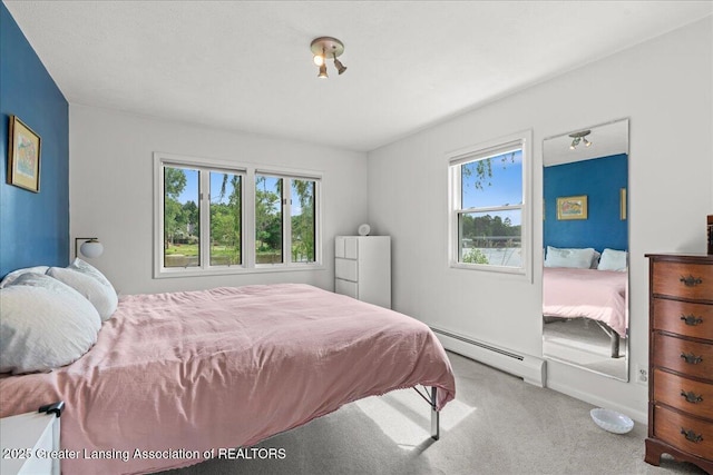 10138 Baron Blvd, Dimondale, MI 48821 - carpeted bedroom with baseboard heating and multiple windows