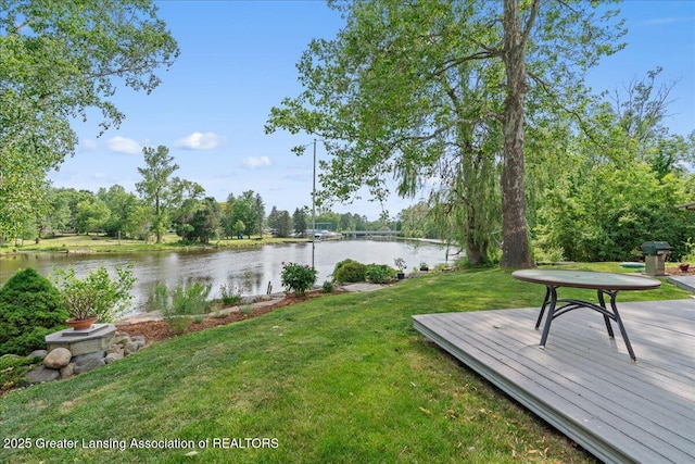 10138 Baron Blvd, Dimondale, MI 48821 - view of grassy yard featuring a deck with water view