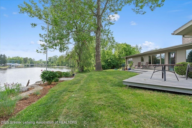 10138 Baron Blvd, Dimondale, MI 48821 - view of grassy yard with a deck with water view