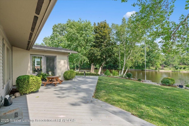 10138 Baron Blvd, Dimondale, MI 48821 - view of grassy yard with a deck with water view and view of wooded area