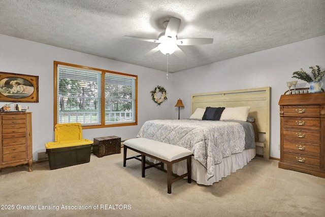 14235 Saxton Rd, Springport, MI 49284 - bedroom with light carpet, a textured ceiling, and a ceiling fan