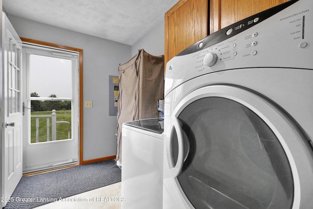 14235 Saxton Rd, Springport, MI 49284 - washroom with cabinet space, washing machine and dryer, electric panel, and a textured ceiling