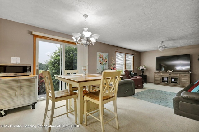 14235 Saxton Rd, Springport, MI 49284 - dining room with a chandelier, a textured ceiling, carpet, and a ceiling fan