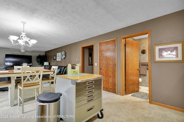 14235 Saxton Rd, Springport, MI 49284 - kitchen with a chandelier, a textured ceiling, pendant lighting, and light carpet