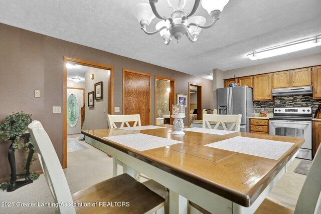 14235 Saxton Rd, Springport, MI 49284 - dining space featuring a chandelier and a textured ceiling