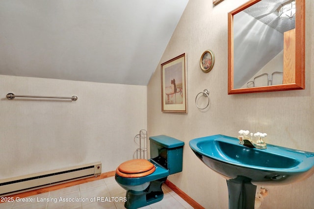 14235 Saxton Rd, Springport, MI 49284 - half bath featuring a baseboard heating unit, lofted ceiling, and tile patterned floors