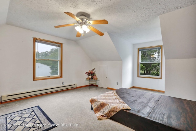 14235 Saxton Rd, Springport, MI 49284 - carpeted bedroom with a baseboard heating unit, vaulted ceiling, multiple windows, a ceiling fan, and a textured ceiling
