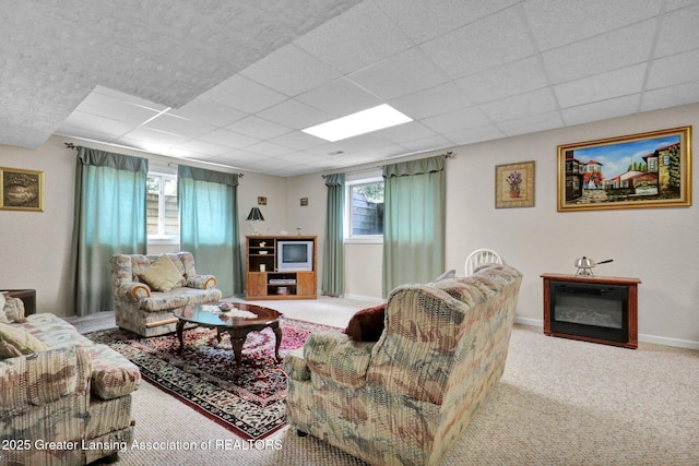 1823 Cricket Ln, East Lansing, MI 48823 - carpeted living area featuring a drop ceiling and baseboards