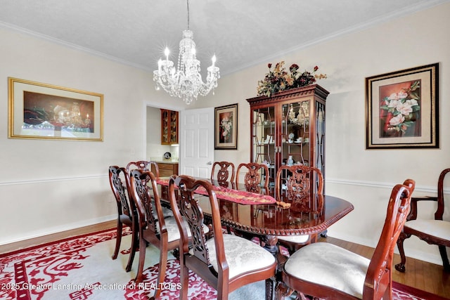 1823 Cricket Ln, East Lansing, MI 48823 - dining space with a chandelier, wood finished floors, and crown molding
