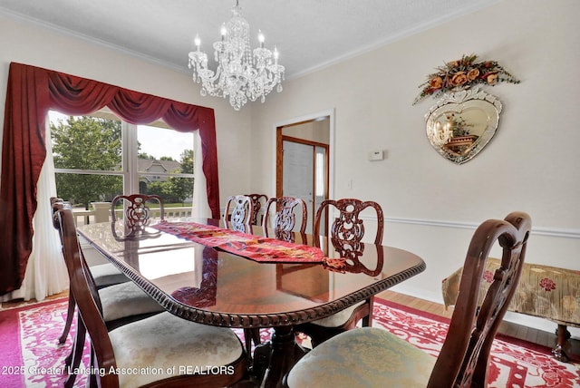 1823 Cricket Ln, East Lansing, MI 48823 - dining space with a chandelier, crown molding, and wood finished floors
