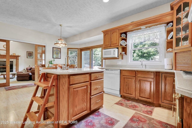 1823 Cricket Ln, East Lansing, MI 48823 - kitchen featuring white appliances, plenty of natural light, light countertops, a textured ceiling, and recessed lighting